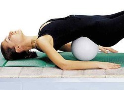 Exercise with a cushion under the lower part of the back
